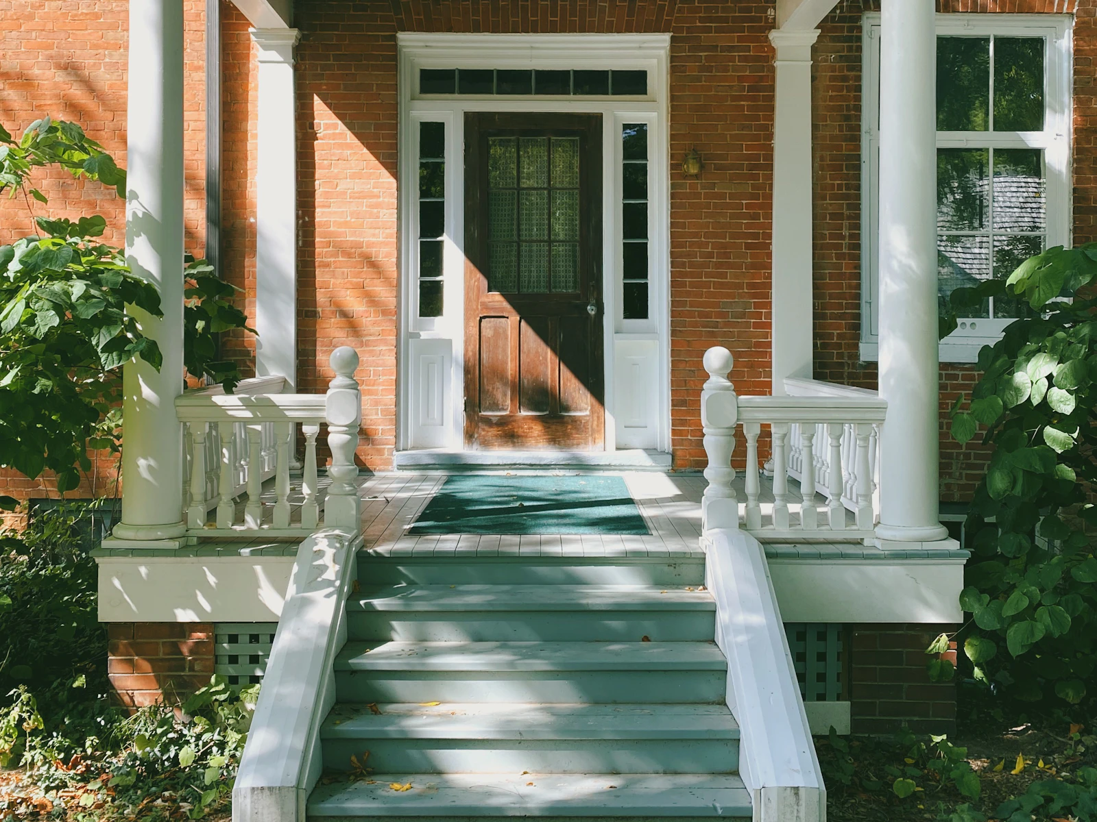 Illustrative photo of brown brick house with white wooden door