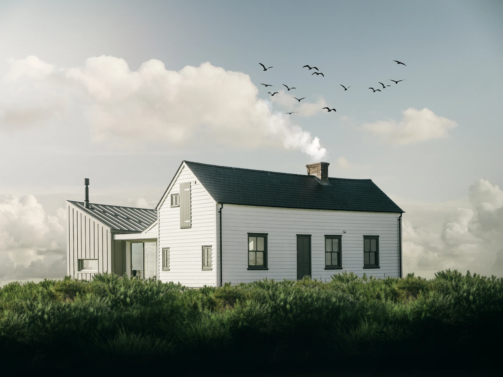 Illustrative photo of a white modern farmhouse with black windows under a soft cloudy sky