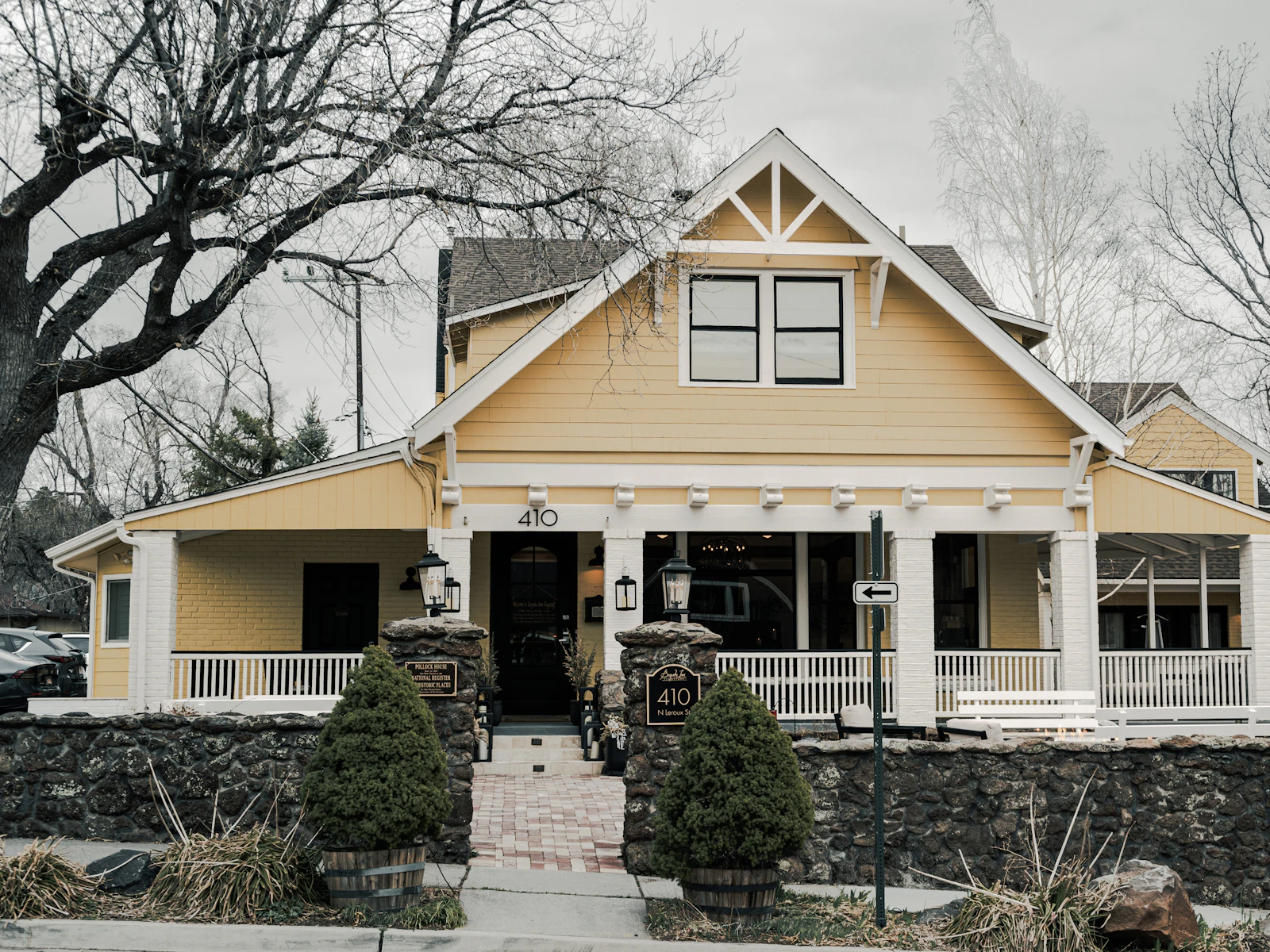 Illustrative photo of a charming yellow house with a large porch