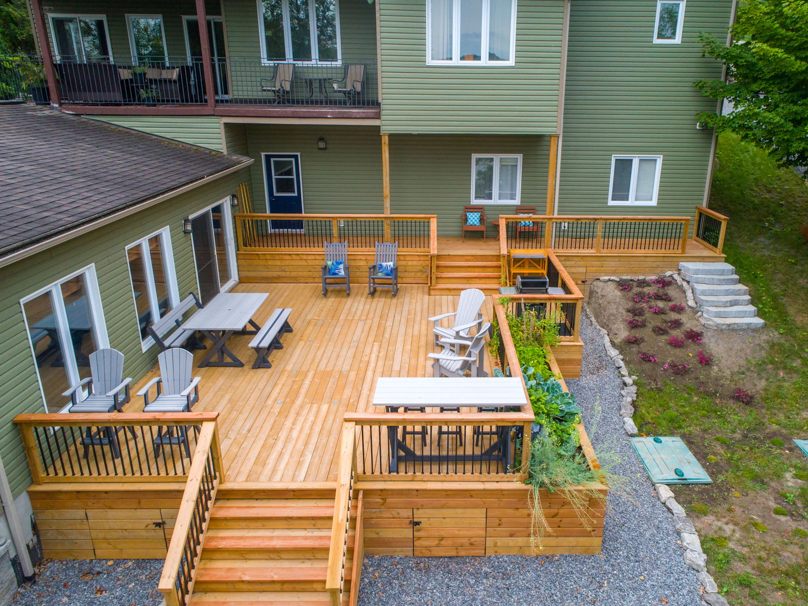 Illustrative photo of a deck with chairs and tables on it next to a house