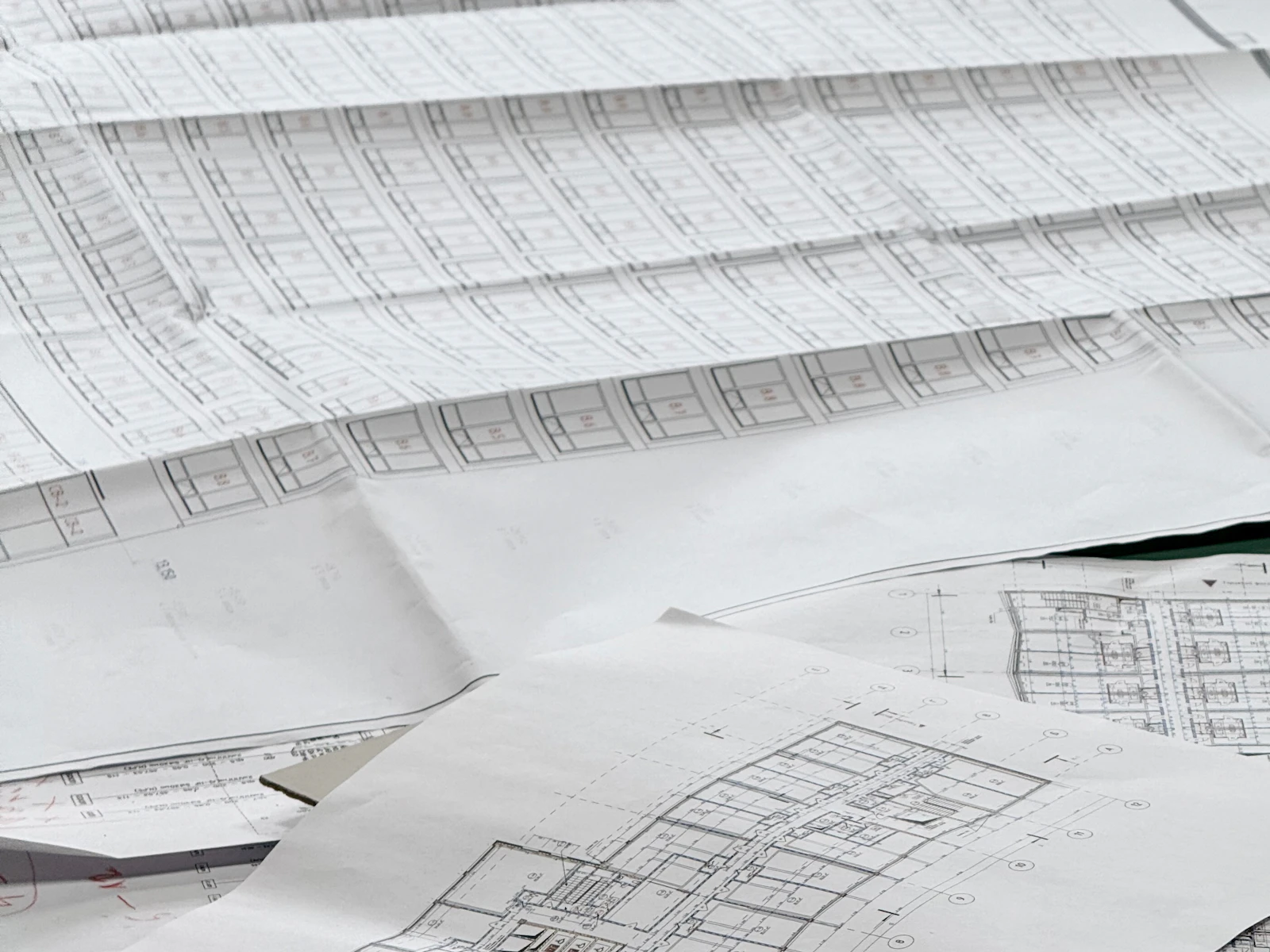 Illustrative photo of architectural blueprints spread across a work surface