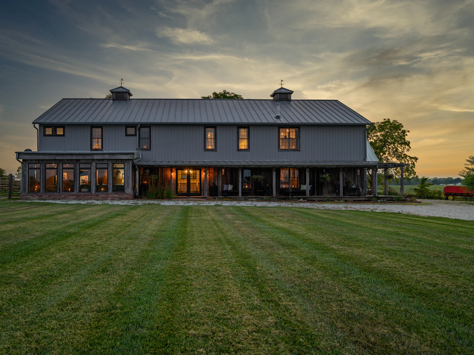 Illustrative photo of a refined barn-style country house on open land