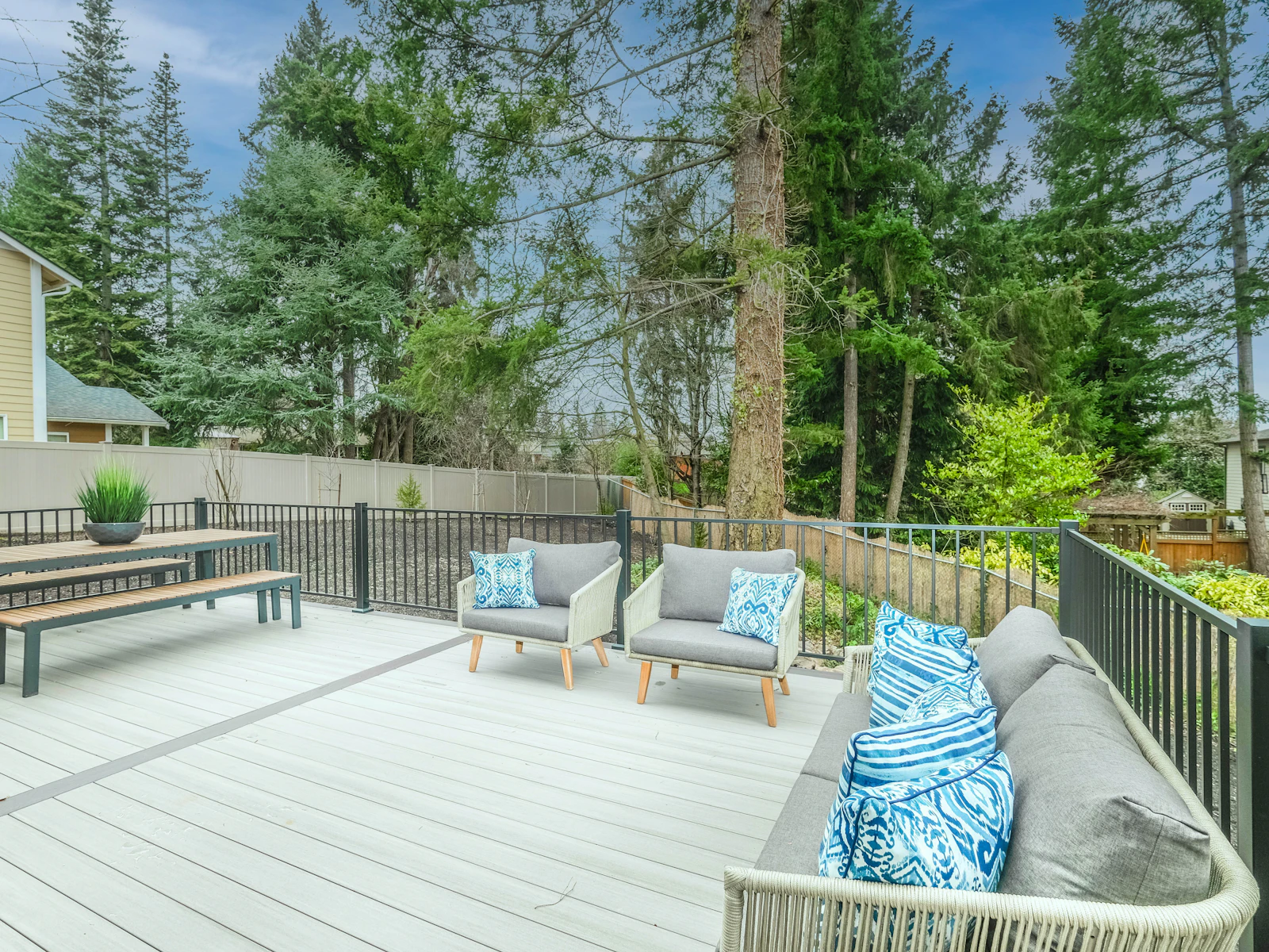Illustrative photo of white wooden bench on wooden deck
