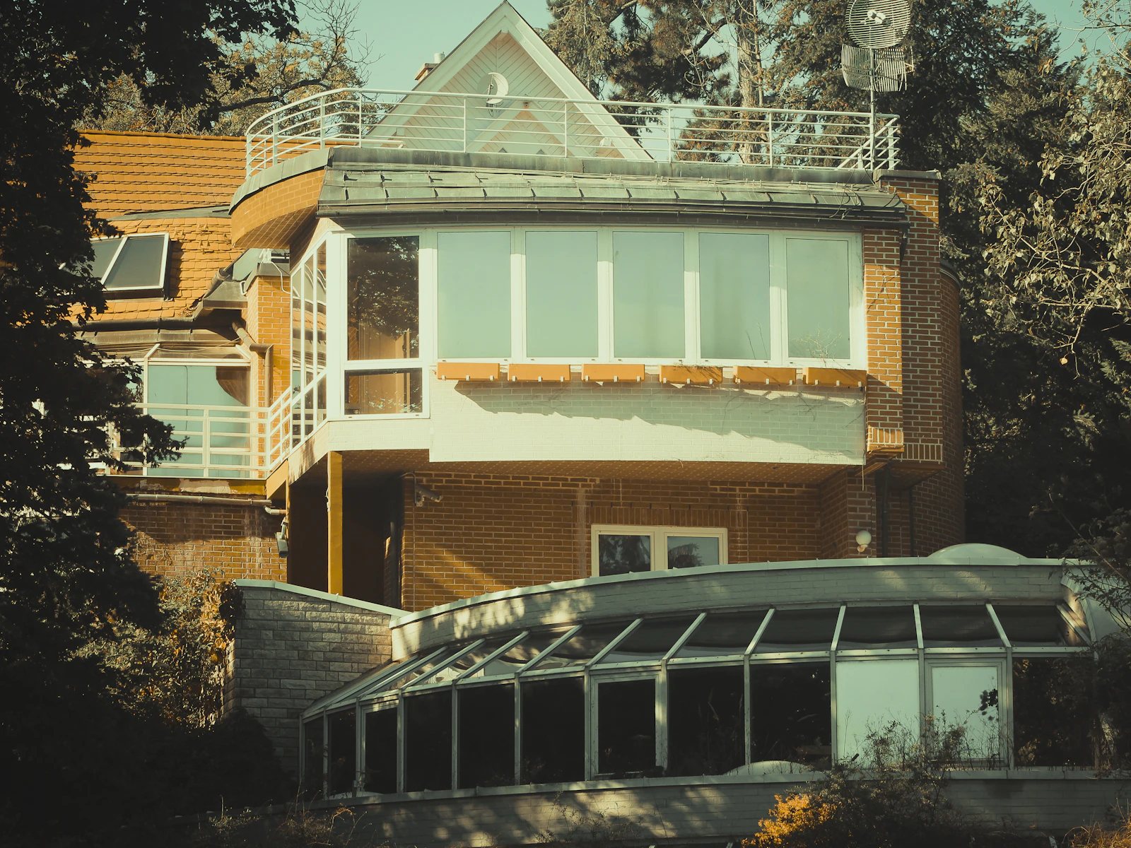 Illustrative photo of modern house with large windows and sunroom