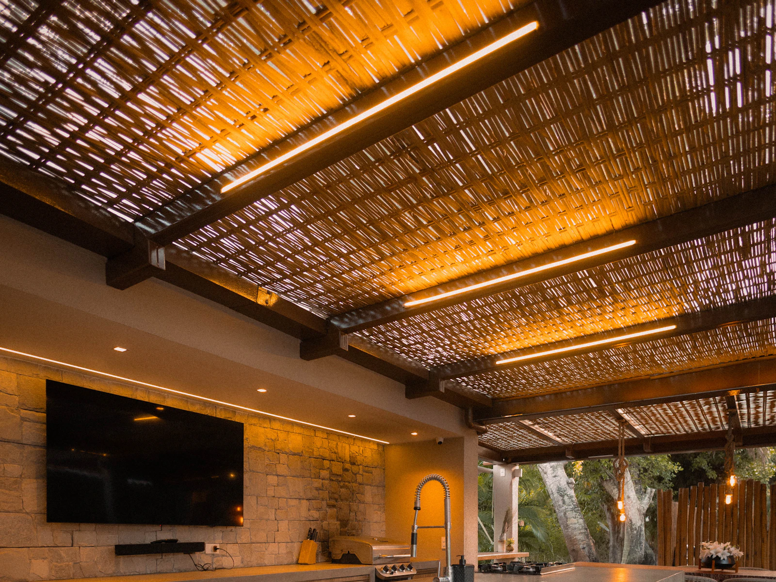 Illustrative photo of modern outdoor kitchen with bar and seating