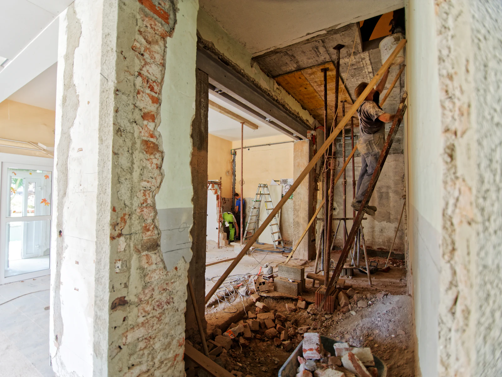 Illustrative photo of man climbing on ladder inside room