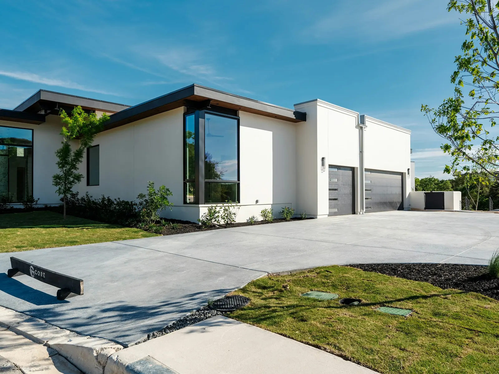Illustrative photo of a new concrete driveway in front of a white house
