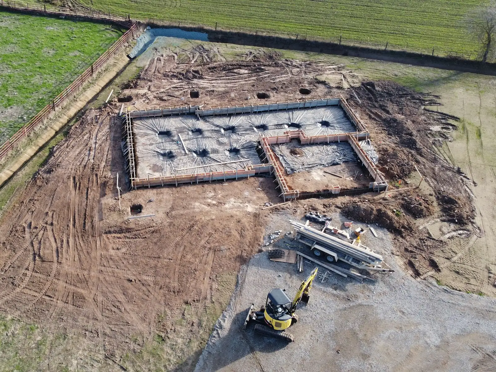 Illustrative aerial photo of a new house foundation and footings on a cleared lot