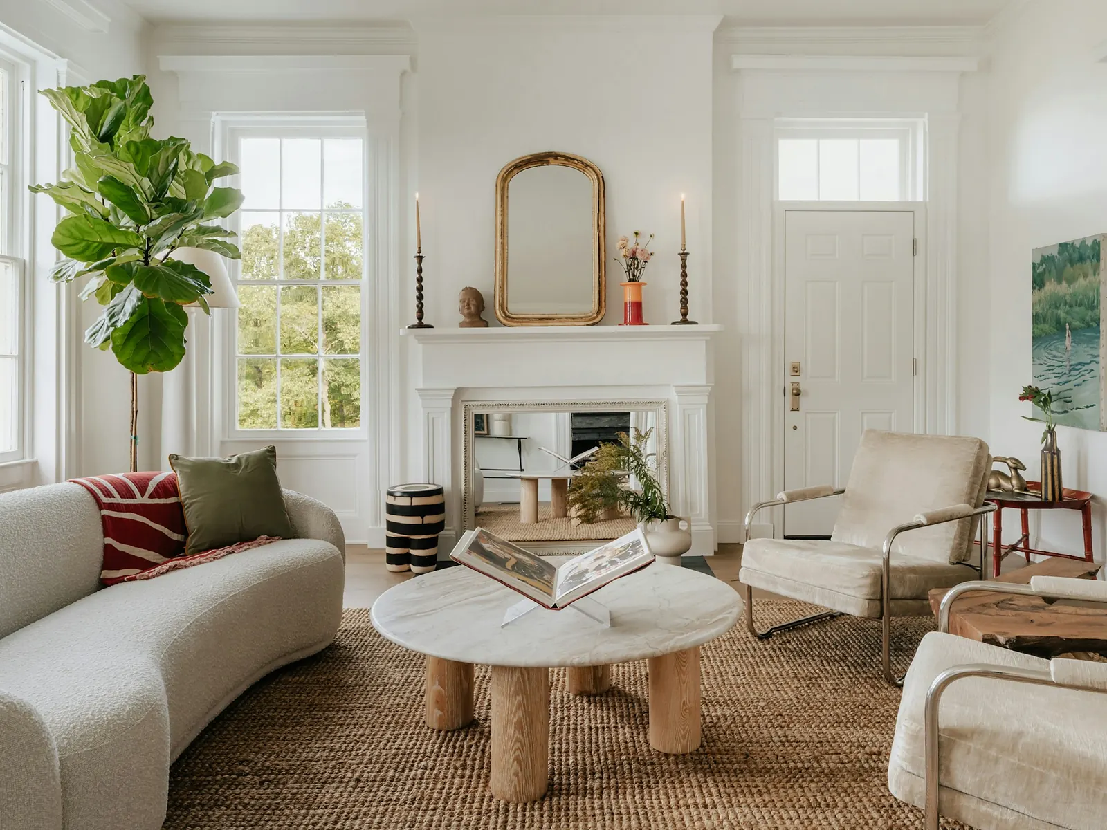 Illustrative photo of a bright living room with a white fireplace and tall windows